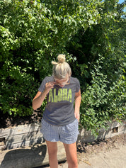 Grey Tee shirt that says Aloha in green letter from the front