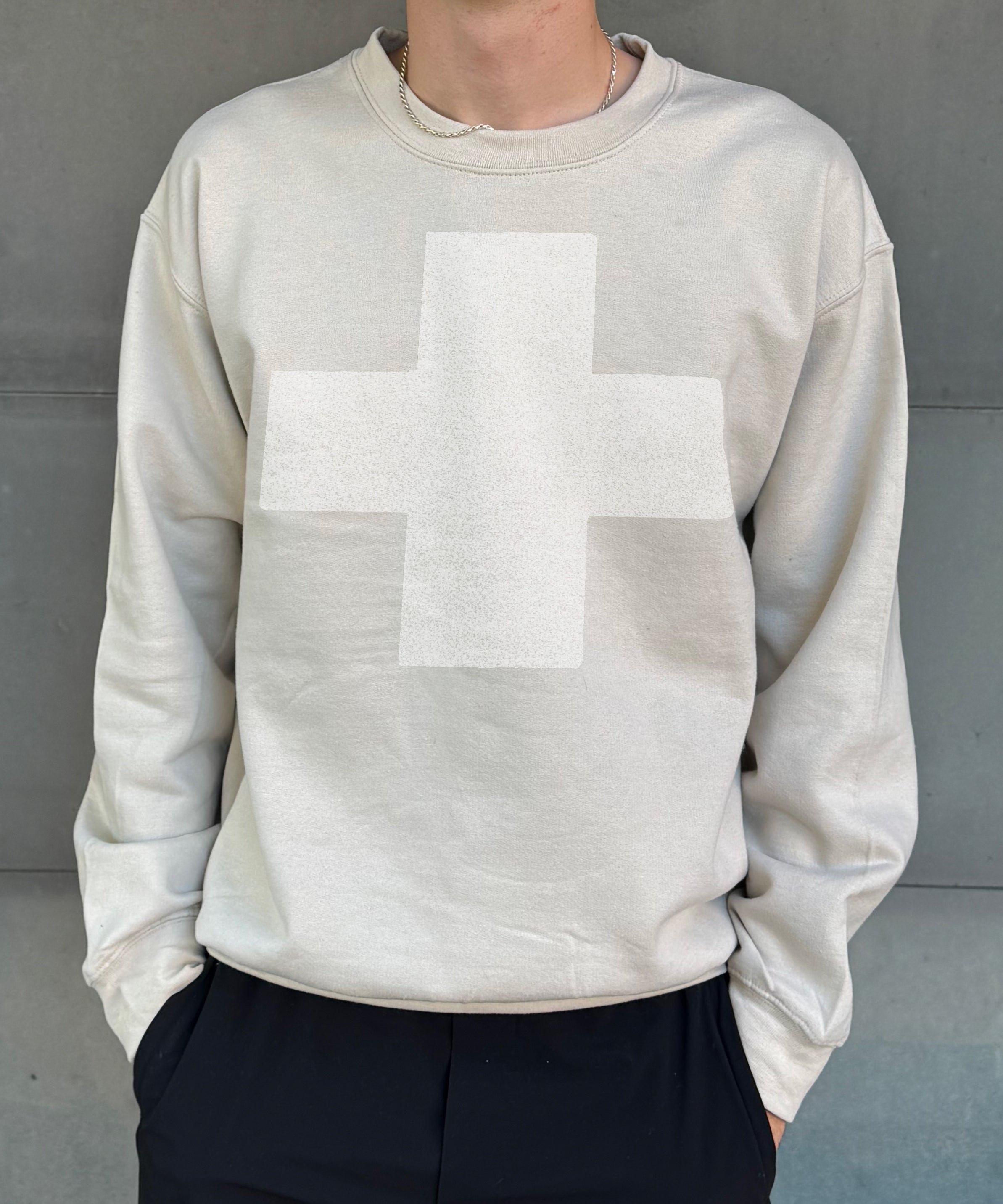 sand colored pullover with a white cross for men