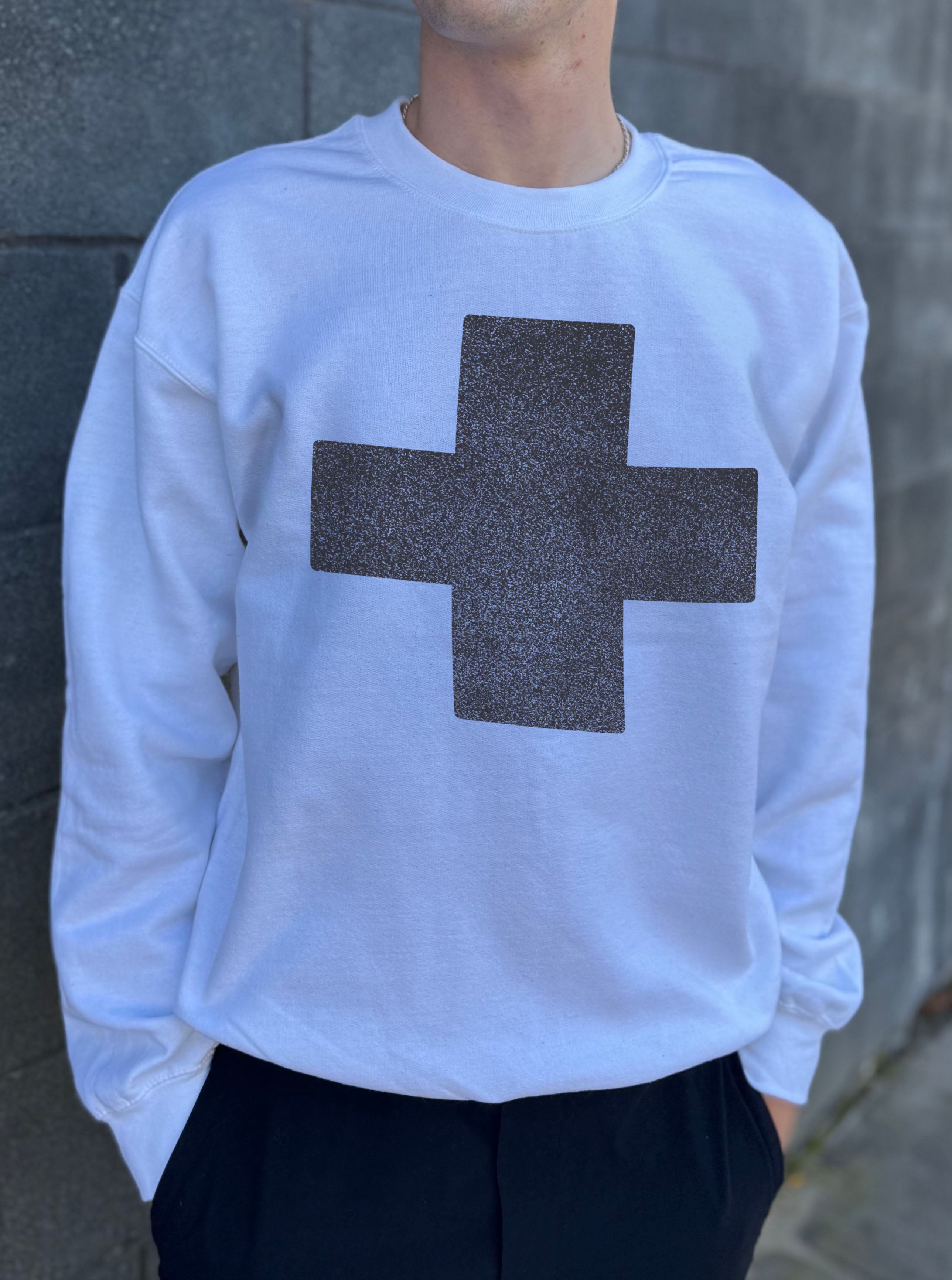 White pullover with a grey cross 