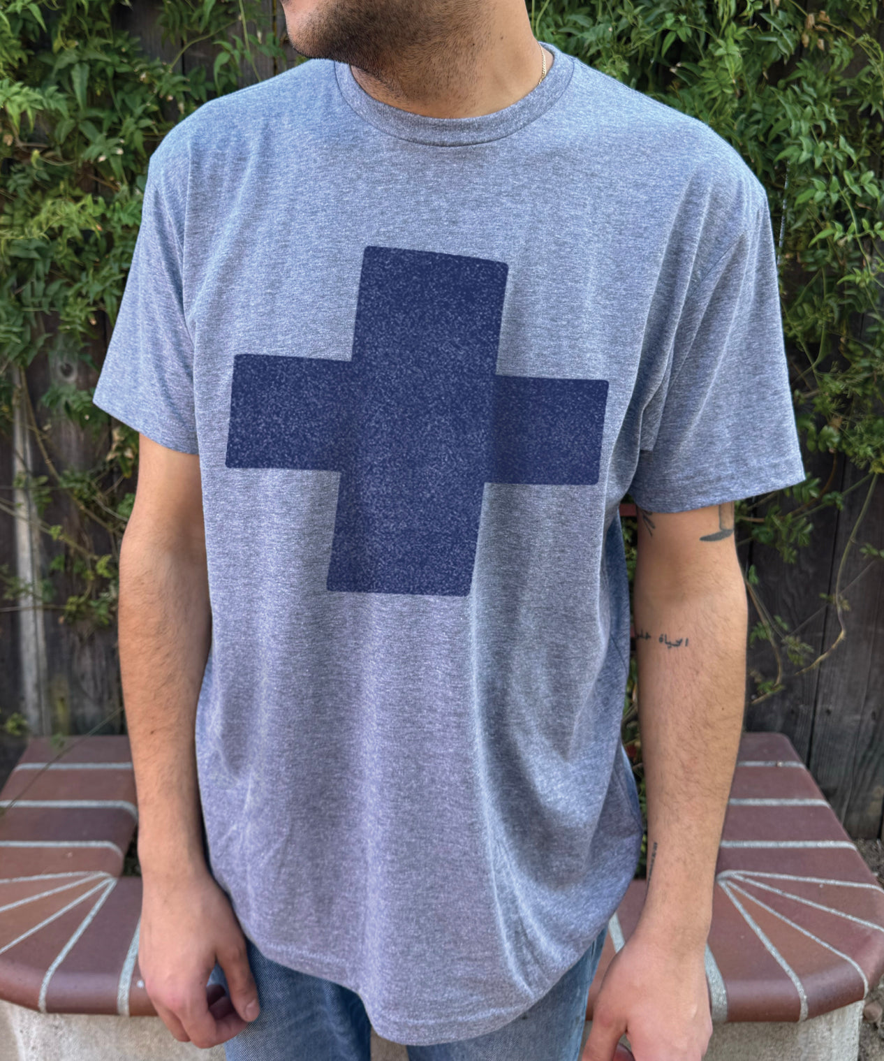 Men's heather colored T-shirt with blue cross