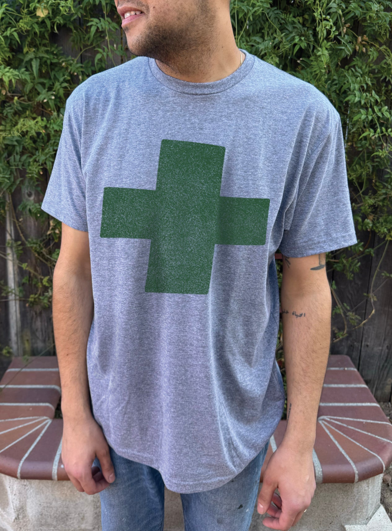 Men's heather colored T-shirt with green cross