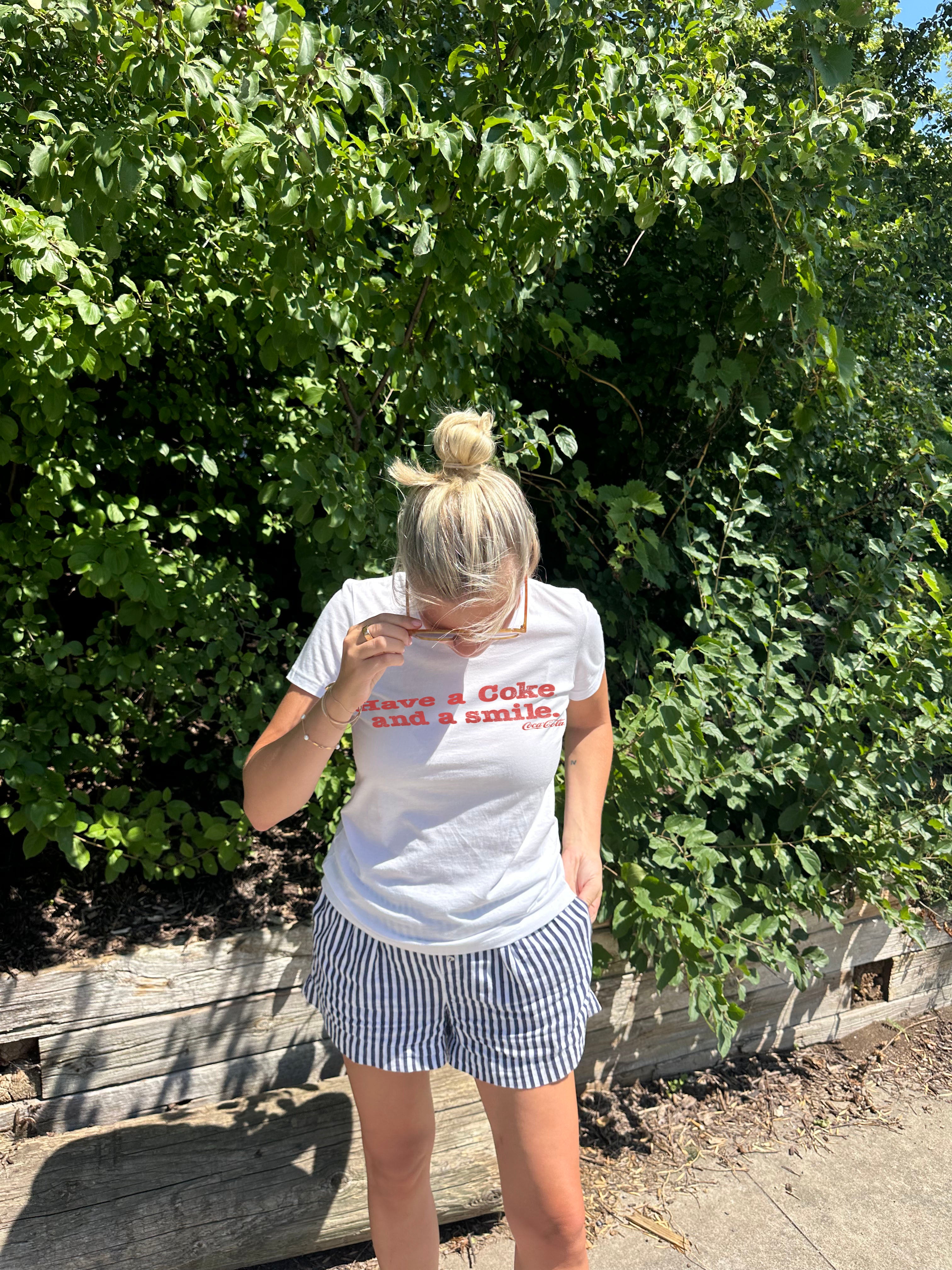 Have a coke and a smile white tee shirt with red letters