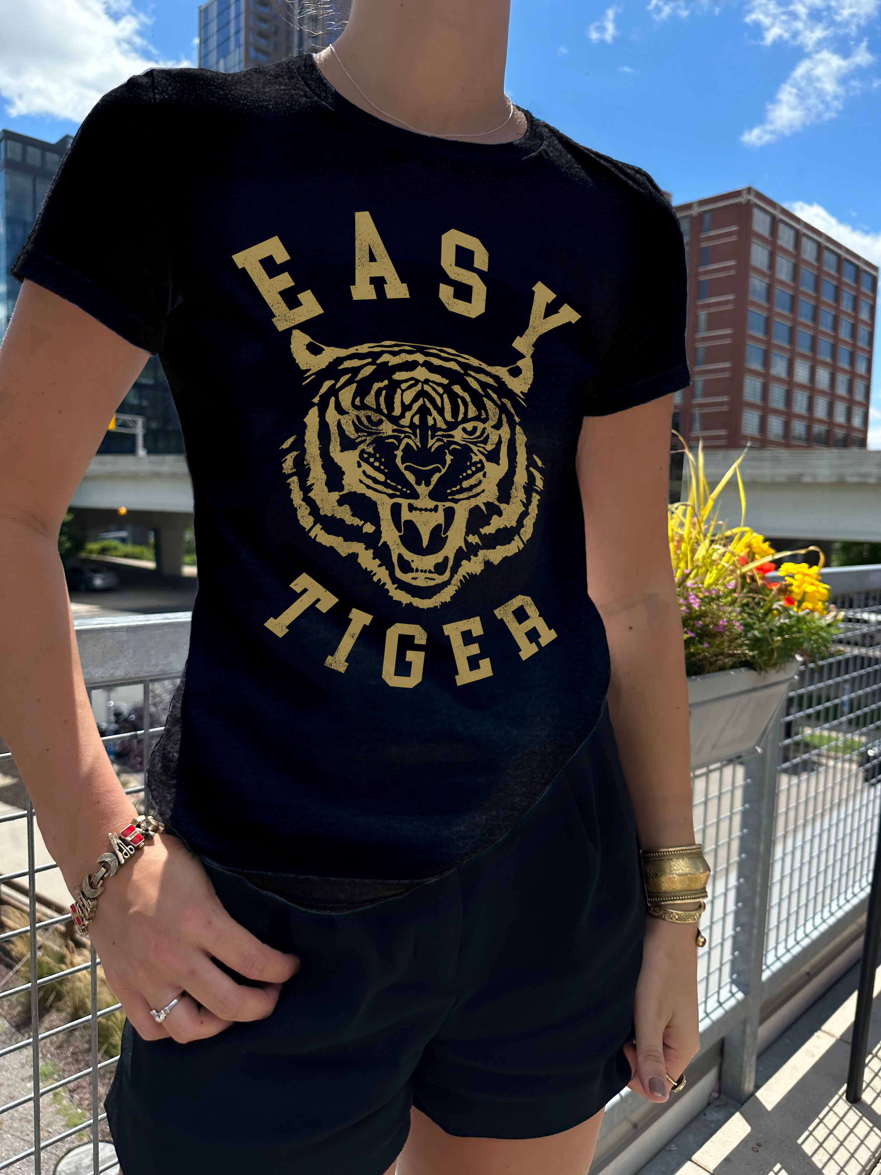 Easy Tiger dark blue tee shirt with gold font on a women in Minneapolis with Tiger Print