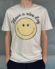 Sand colored mens tshirt that says "Have a nice day" with a smiling face