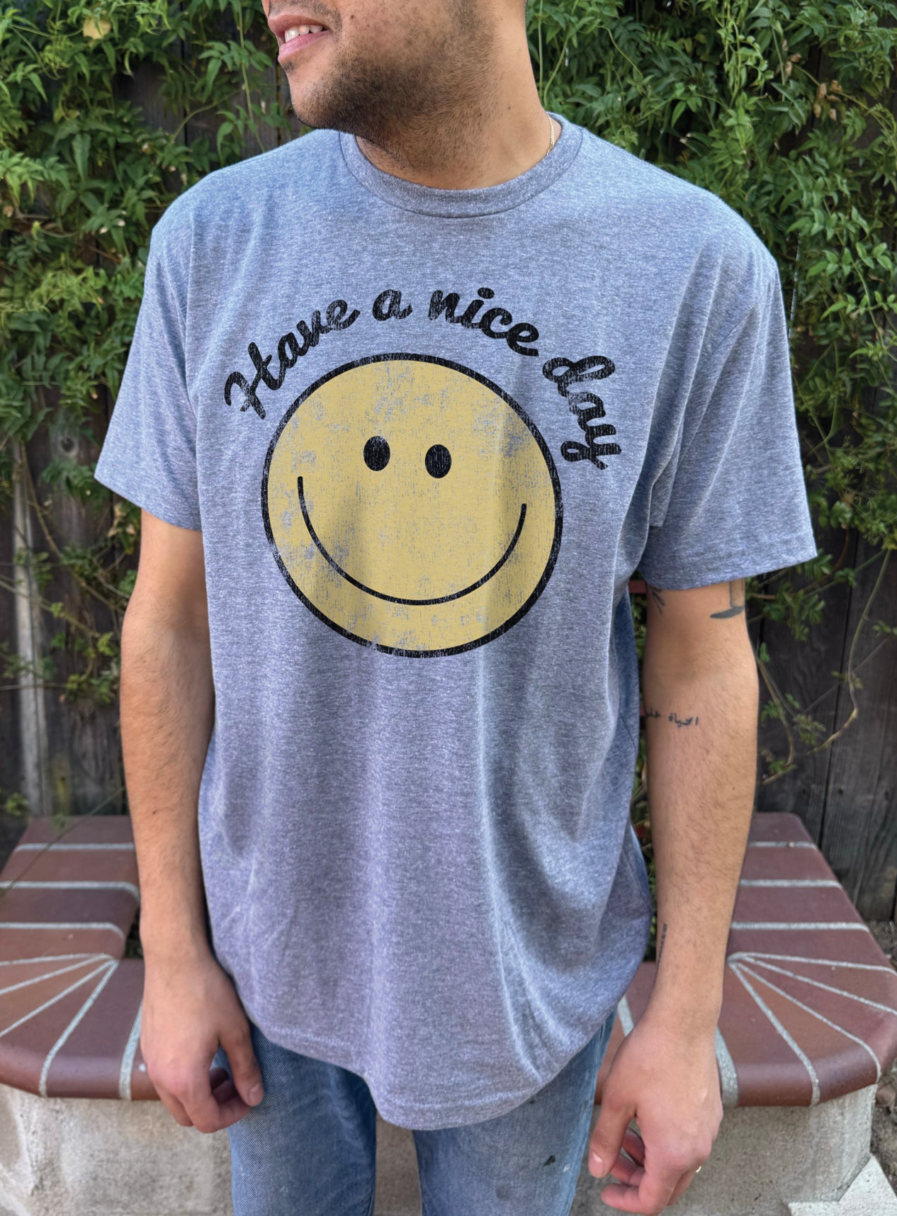 Grey mens tshirt that says "Have a nice day" with a smiling face