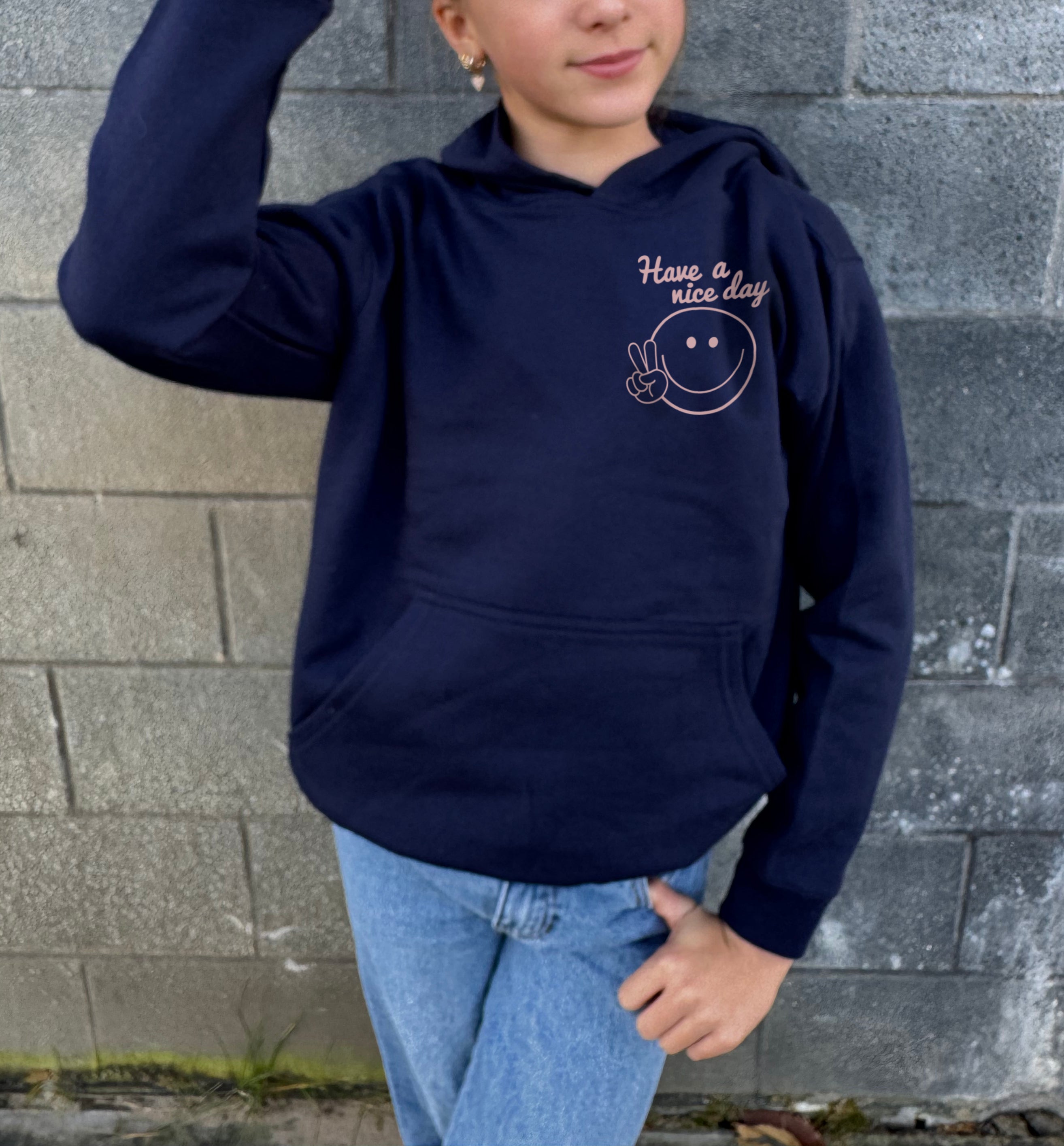 Girl in dark blue hoodie that says "Self Love Club" in rose text 