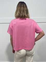 woman in pink Malibu barbie t shirt from behind