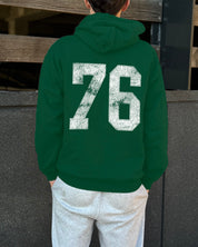 Royal green hoodie that says "76" in white text