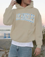 Sand colored hoodie that says "los angeles" in blue text