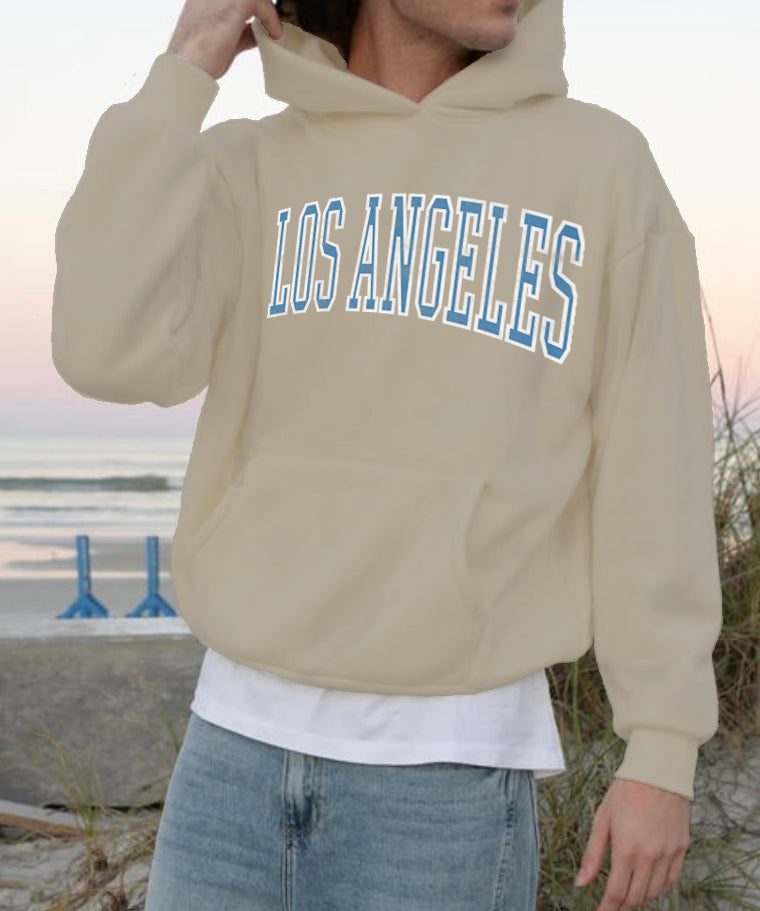 Sand colored hoodie that says "los angeles" in blue text