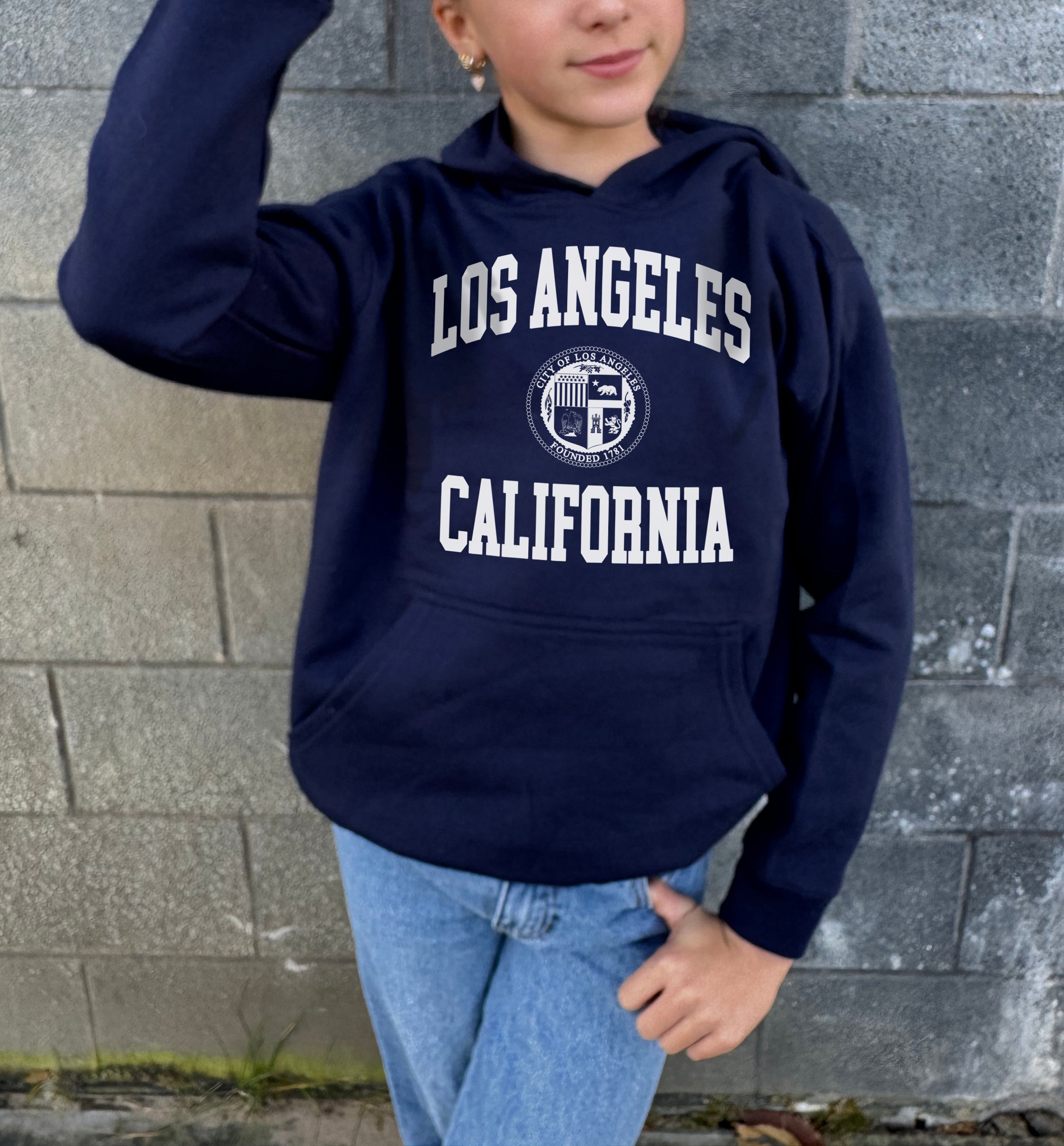 Girl in blue hoodie that says "Los Angeles, California" in white text 