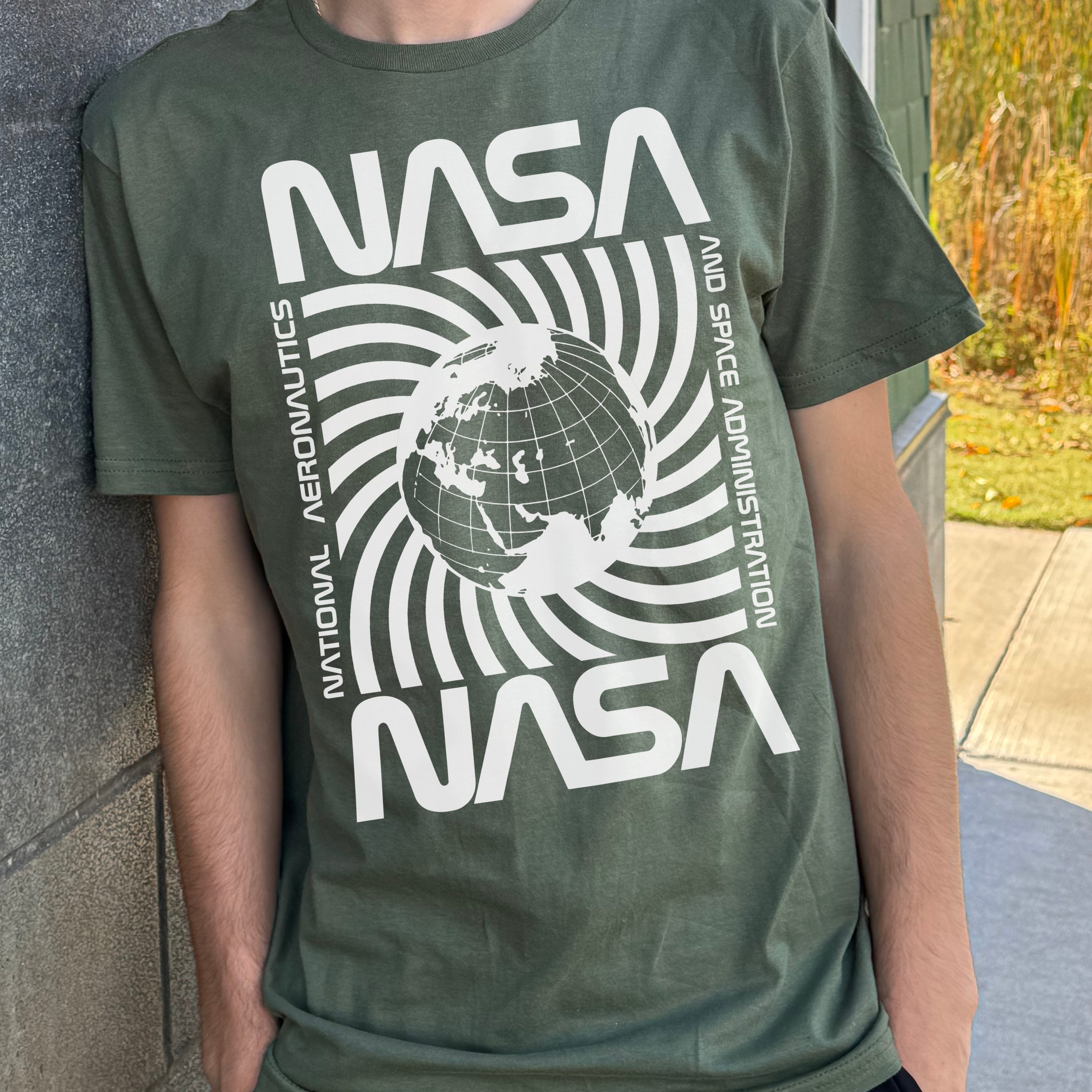 Green "NASA" T-shirt with white spinning planet graphic in the center