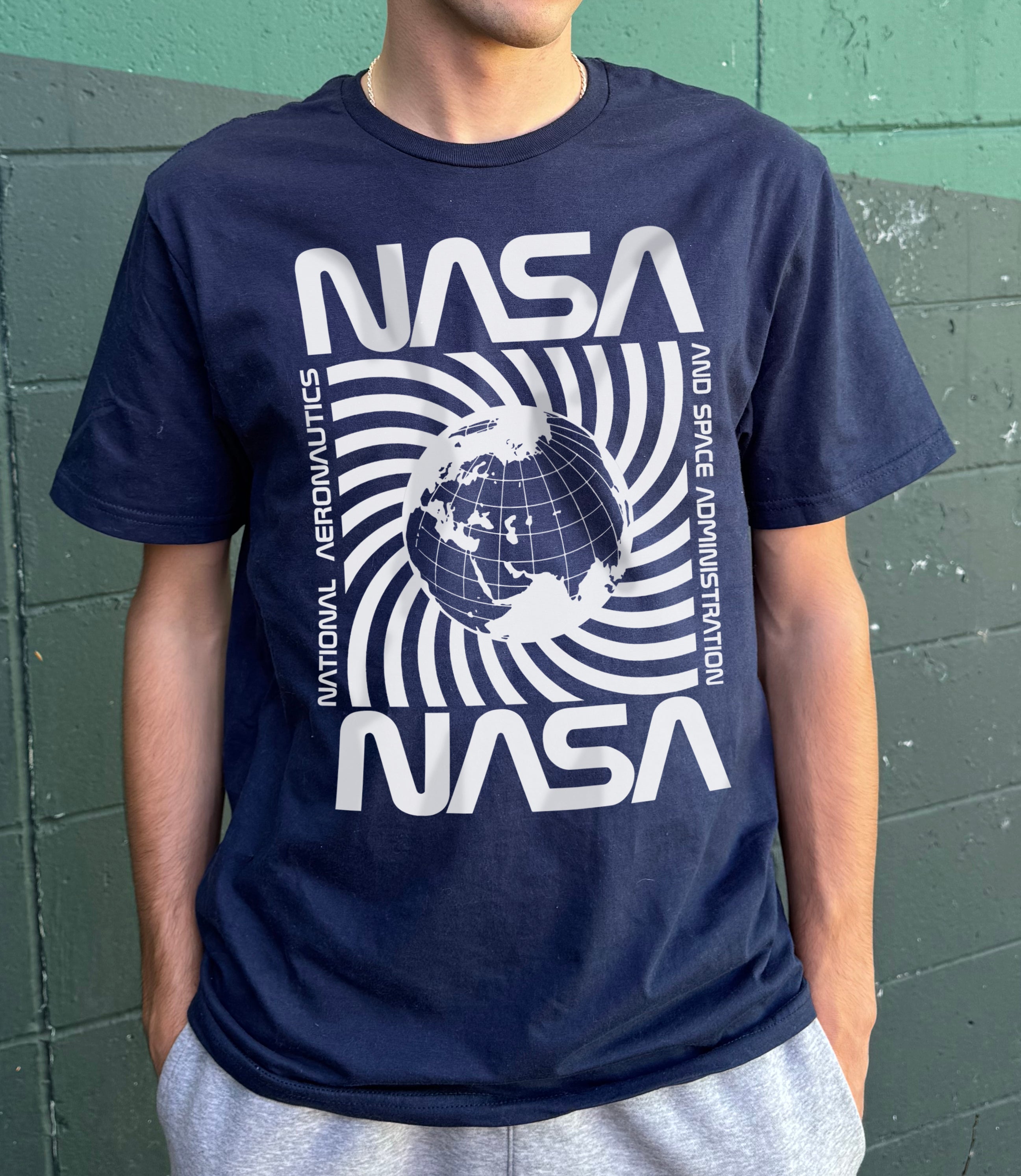 Dark blue "NASA" T-shirt with white spinning planet graphic in the center
