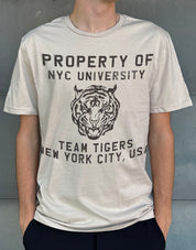 yellow t-shirt for boys that says "Property of NYC University" and a picture of a tiger on it in brown
