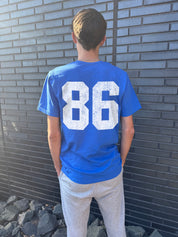 blue t-shirt for boys that says "86" on it in white from the back