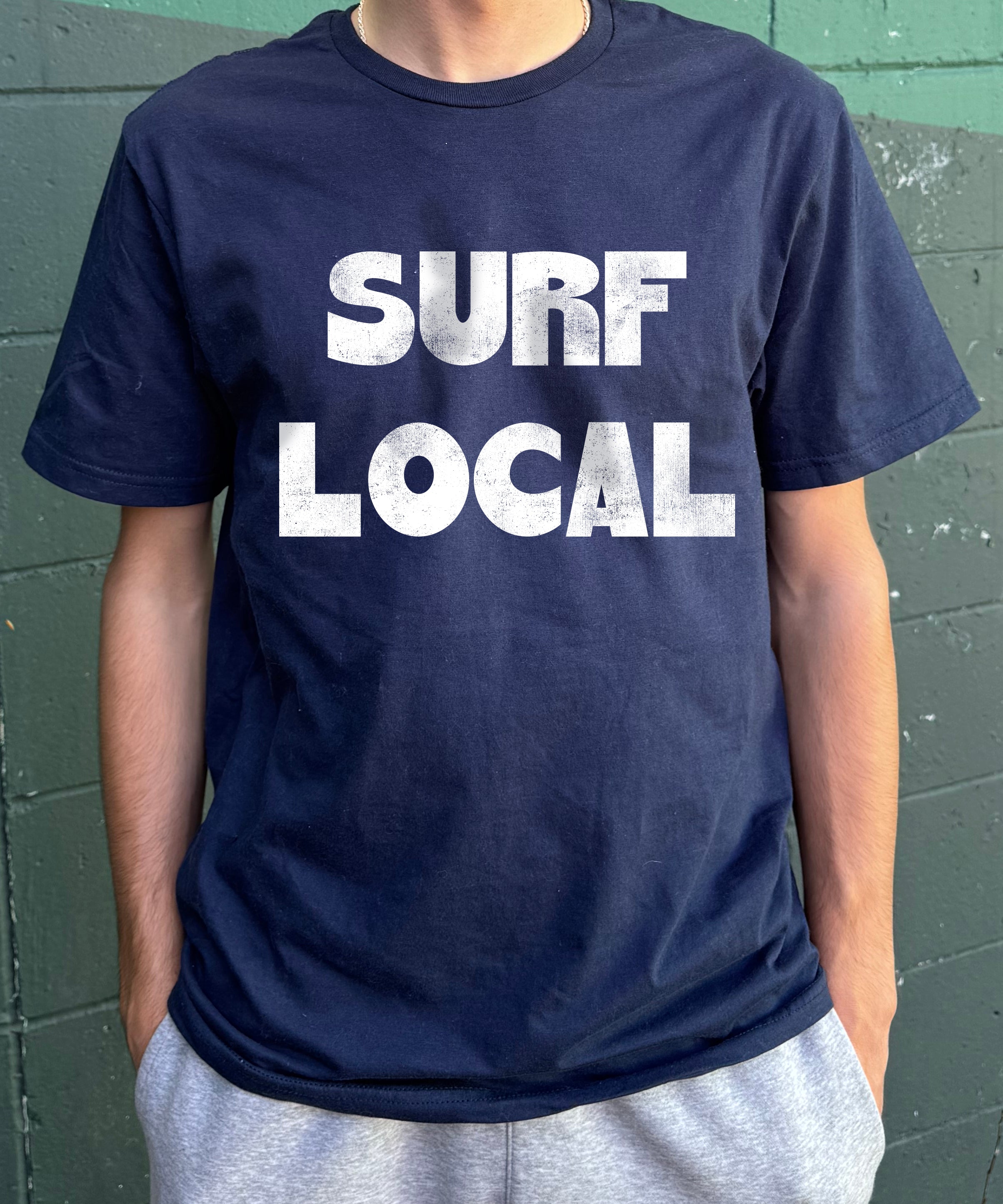 dark blue shirt with white text that says "Surf Local" for boys