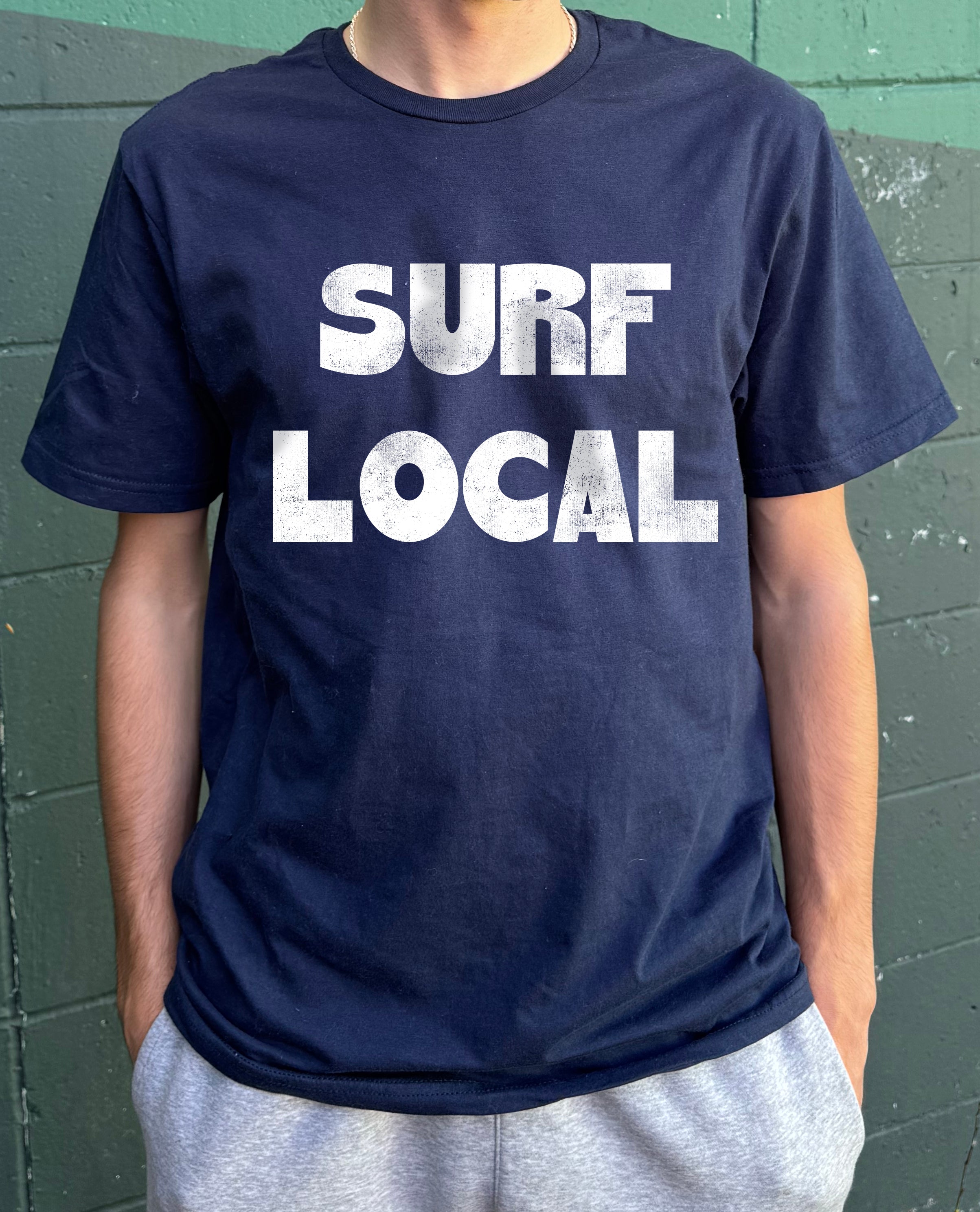 dark blue shirt with white text that says "Surf Local" for boys
