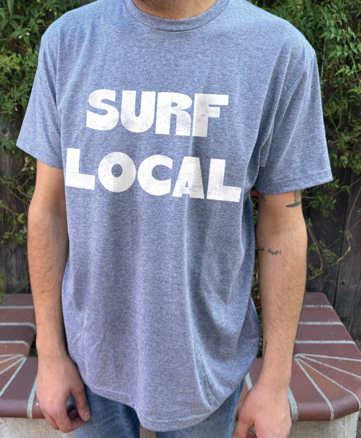 Blue shirt with white text that says "Surf Local"