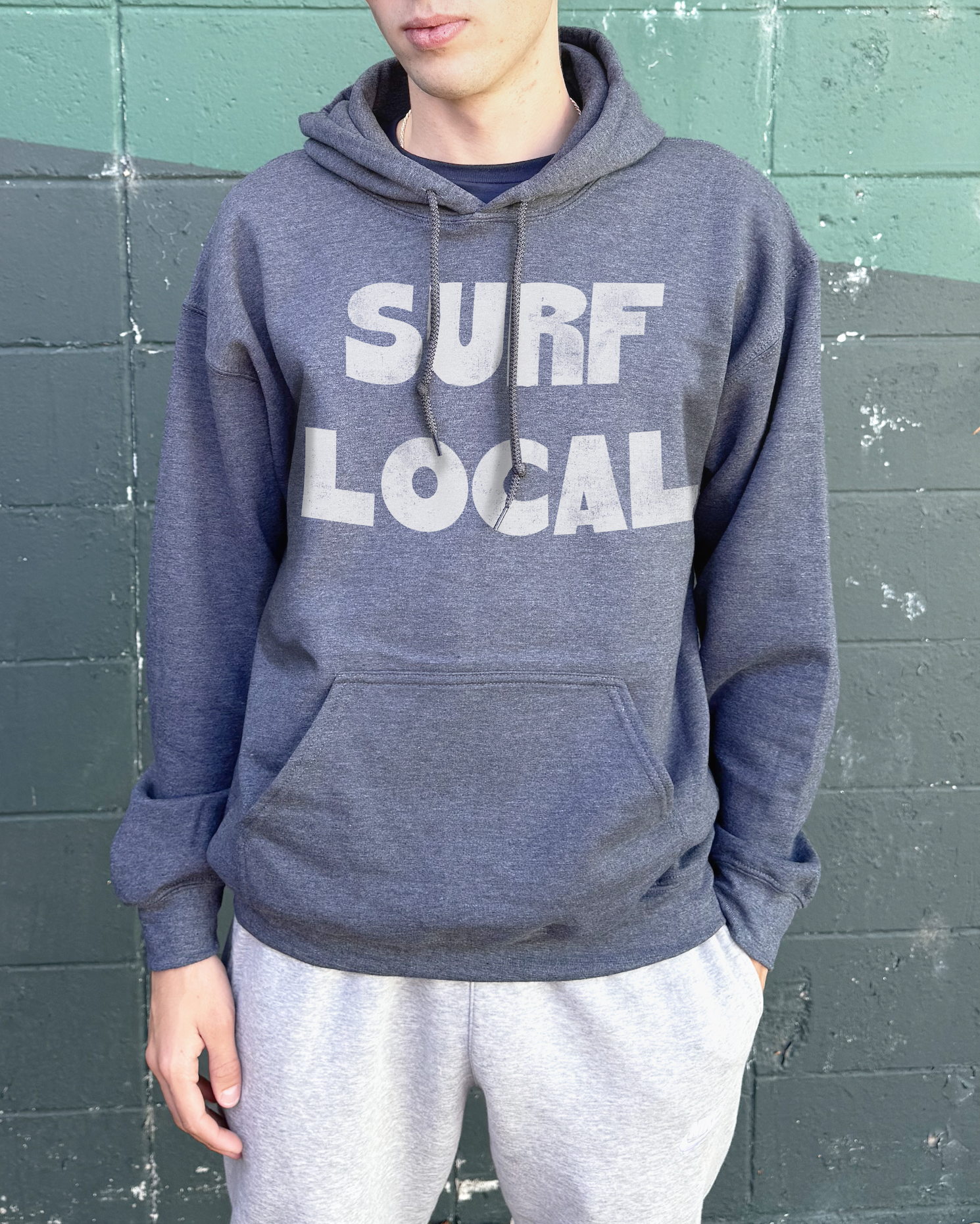 Dark heather hoodie that says "Surf Lcoal" in white text
