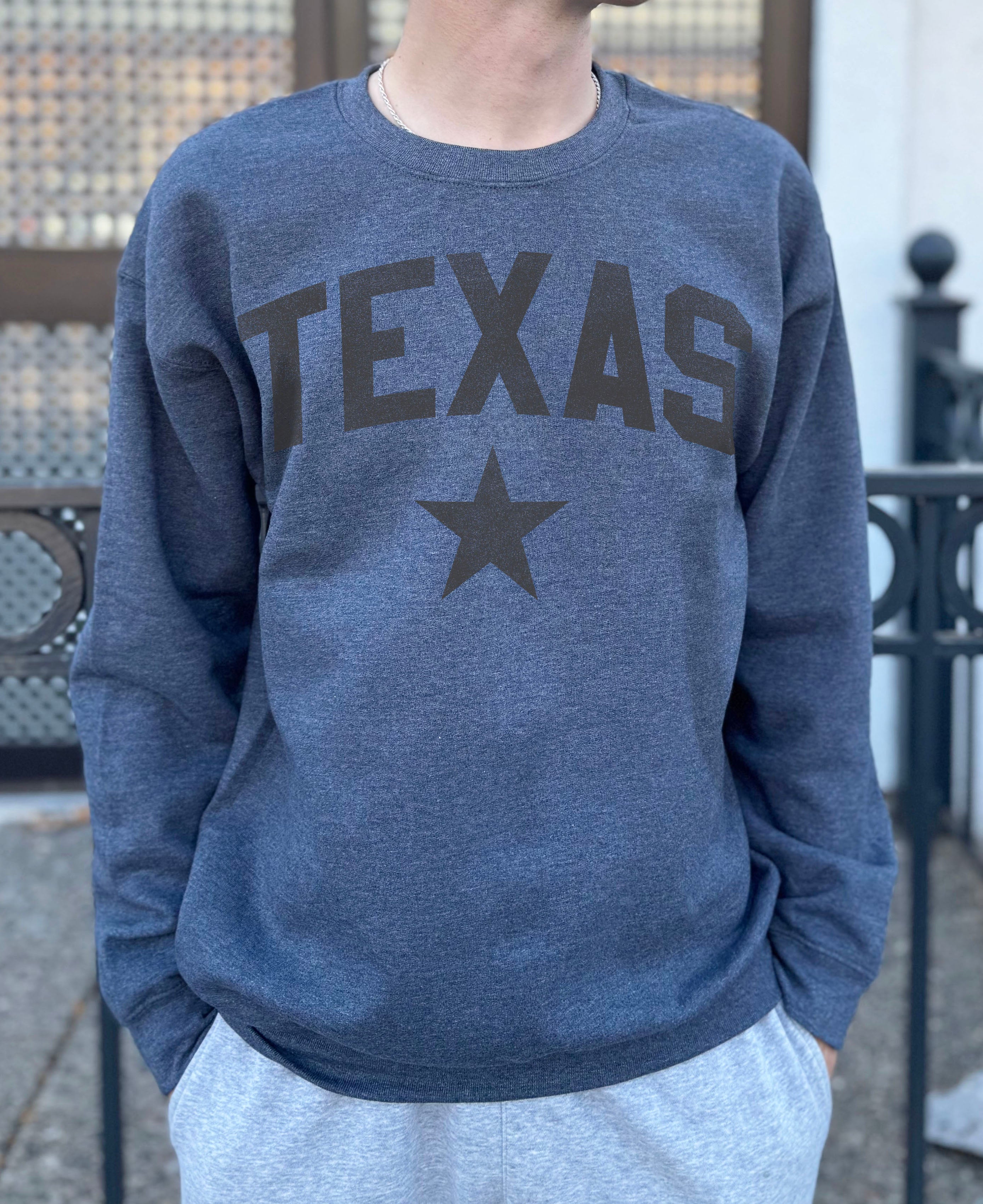grey pullover with brown text that says "Texas"