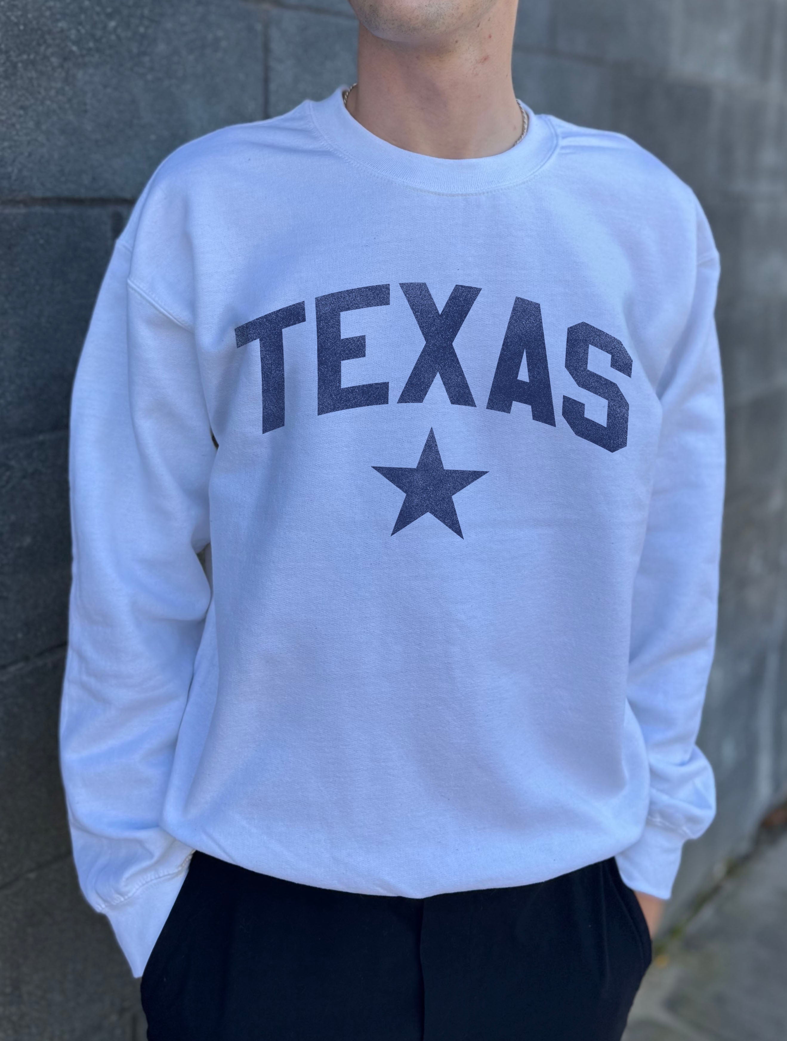 White pullover with blue text that says "Texas"