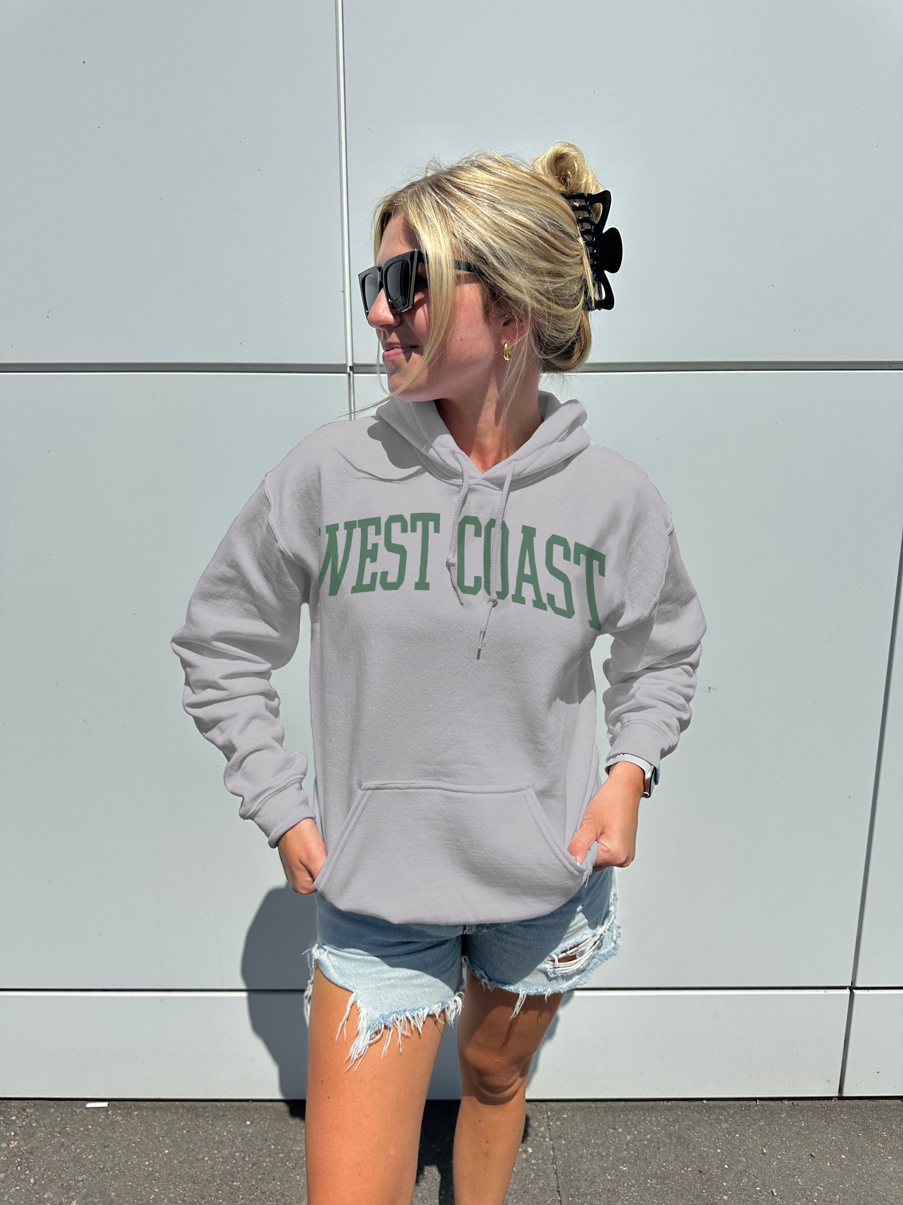 Grey hoodie with green lettering that says "West Coast"